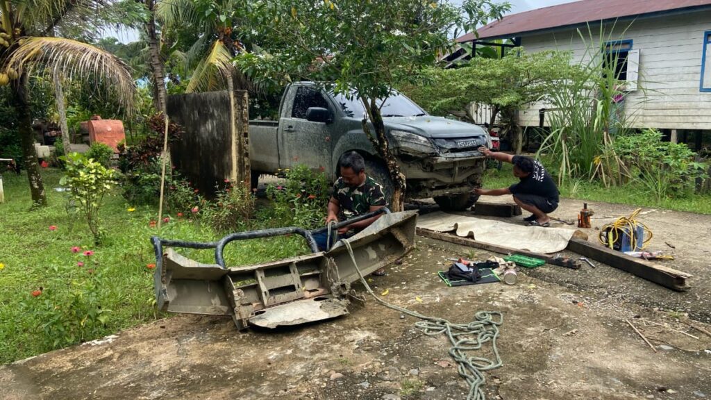 Anggota Satgas TMMD Perbaiki Mobil Pengangkut Material Yang Rusak