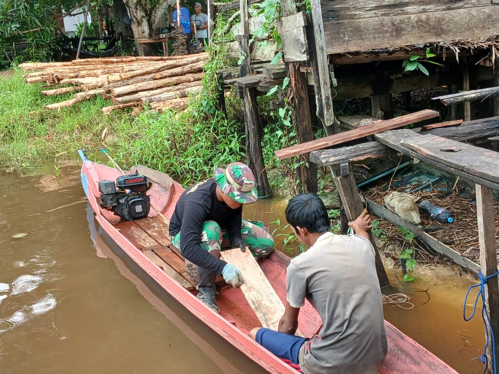 Anggota Satgas TMMD Reguler Ke-123 Bantu Perbaiki Perahu.