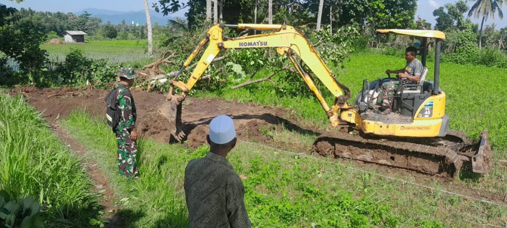 Setelah Pondasi Jembatan, Satgas TMMD Ke-124 Keruk Sawah Jadi Jalan Baru di Bagu